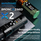 BRONC X2 NEO tattoo machine on a textured surface with branding and product description text.