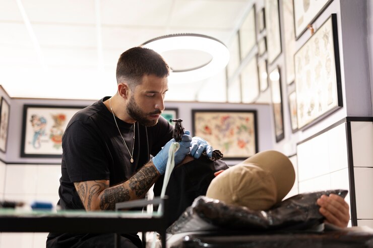1 tattoo-artist-doing-his-job-medium-shot